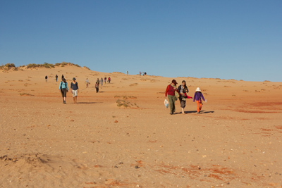 trail walkers on dune
